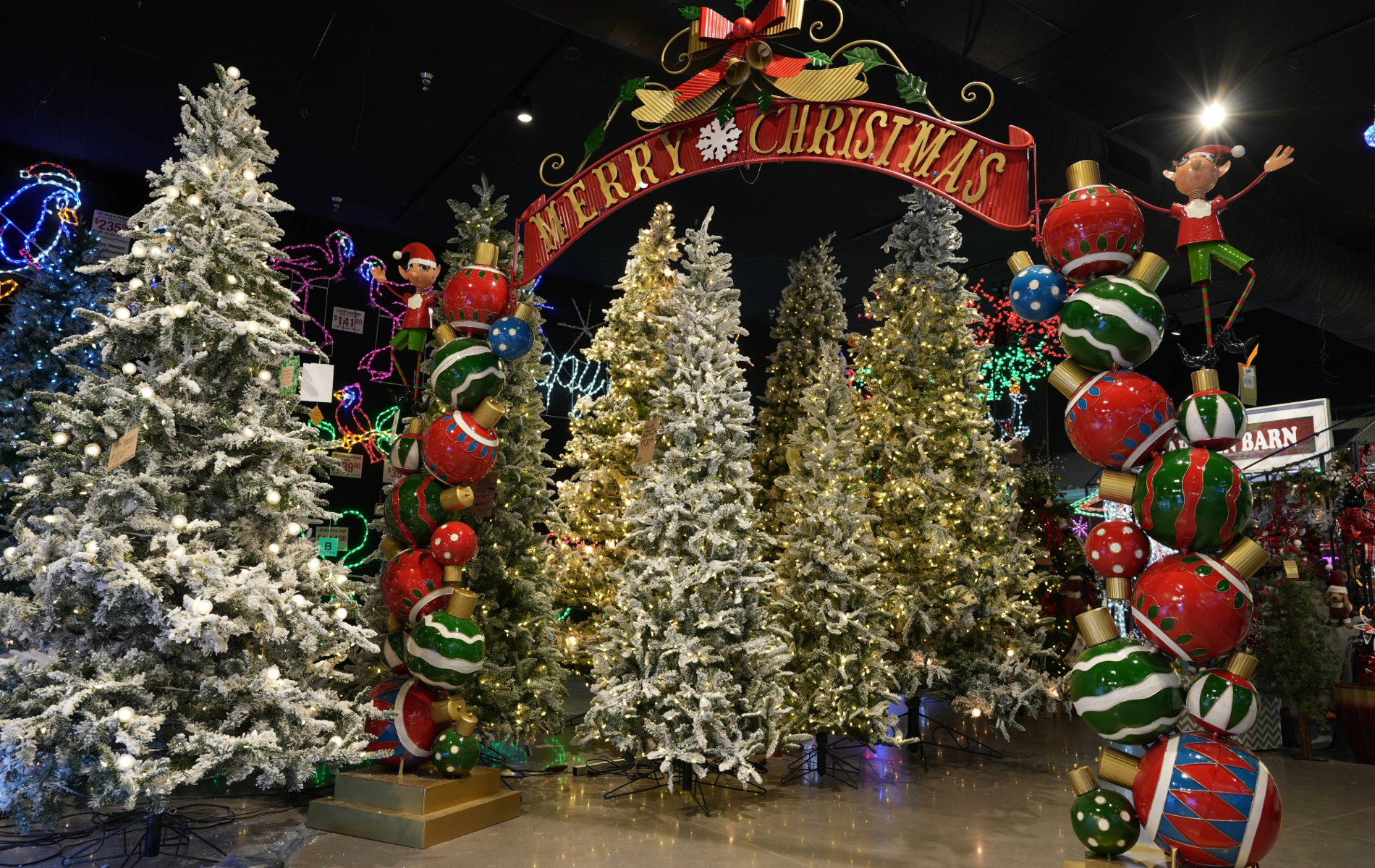 Christmas trees and holiday decorations inside of the Brite Ideas Decorating store.