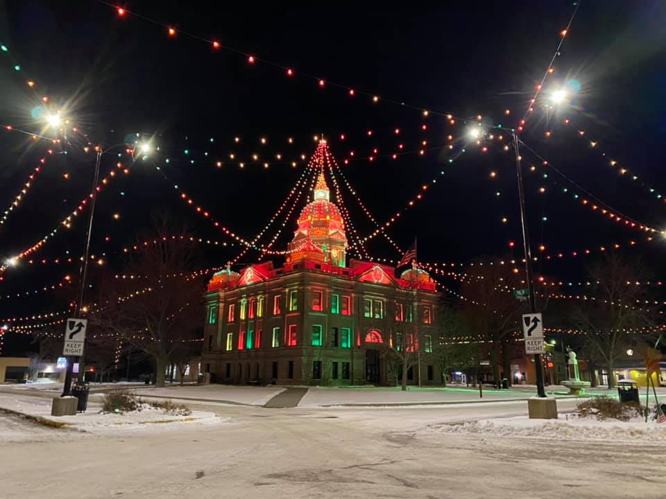Kearney County Courthouse illuminated with red and green holiday lights.