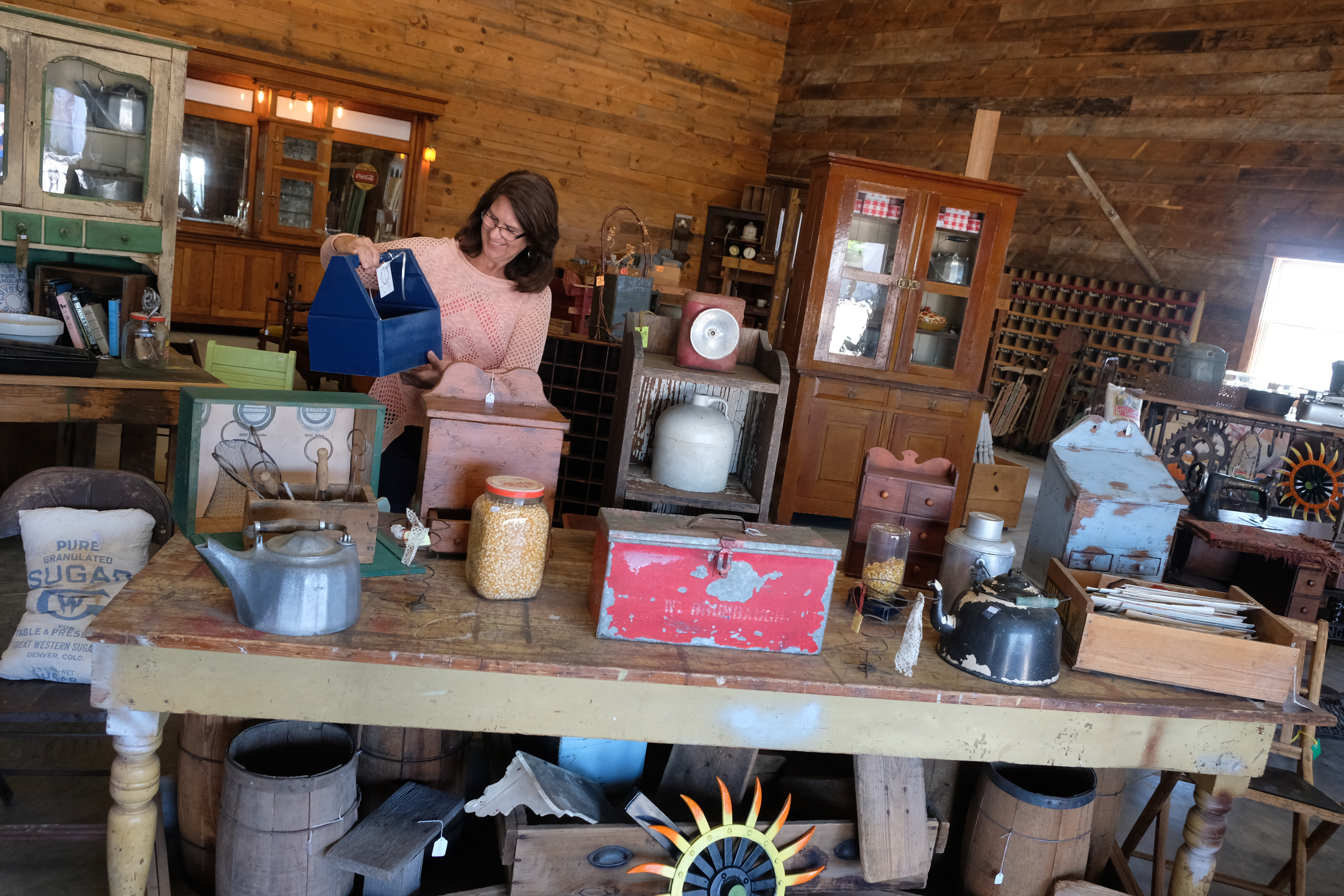 A woman looking at antiques at Grain Bin Antique Town in North Platte.