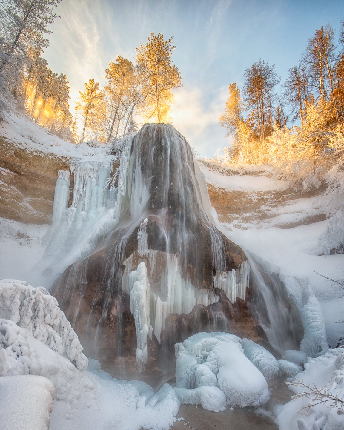 Smith Falls waterfall covered in ice in winter.
