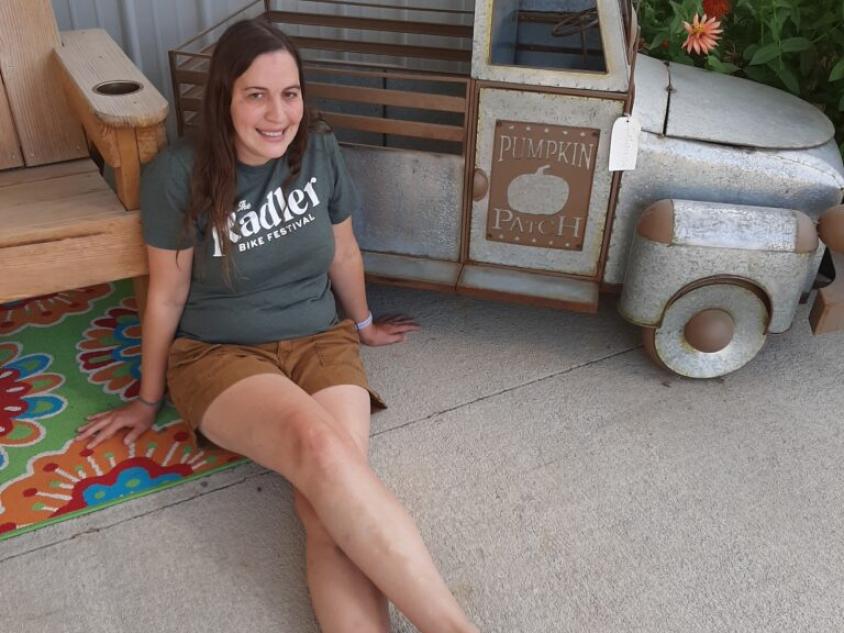Girl next to truck in front of store