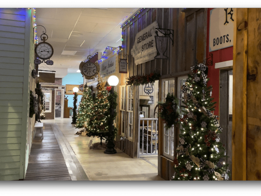 Store front of Plainsman Museum with holiday decorations.