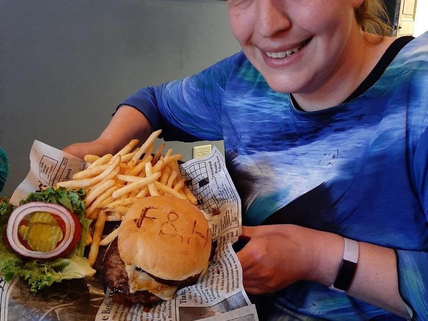 Lady Sharing Burger at stop