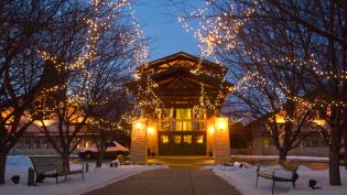 Lied Lodge exterior decoreated with holiday lights.