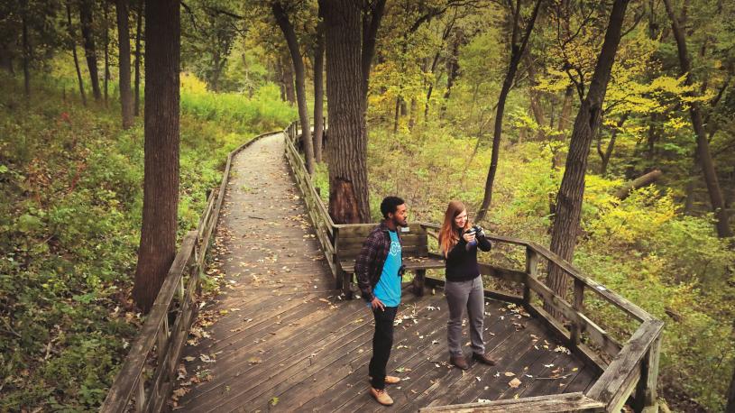 Two people walking the boardwalk paths at Fontenelle Forest.