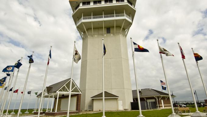 In North Platte, Nebraska, a tall observation deck is surrounded by a ring of flags at Golden Spike Tower